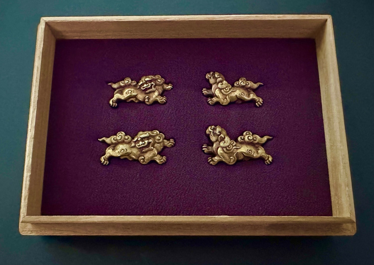 A Set of Four Shishi Gold Menuki Design by Hidekiyo ( signed on the obverse side).