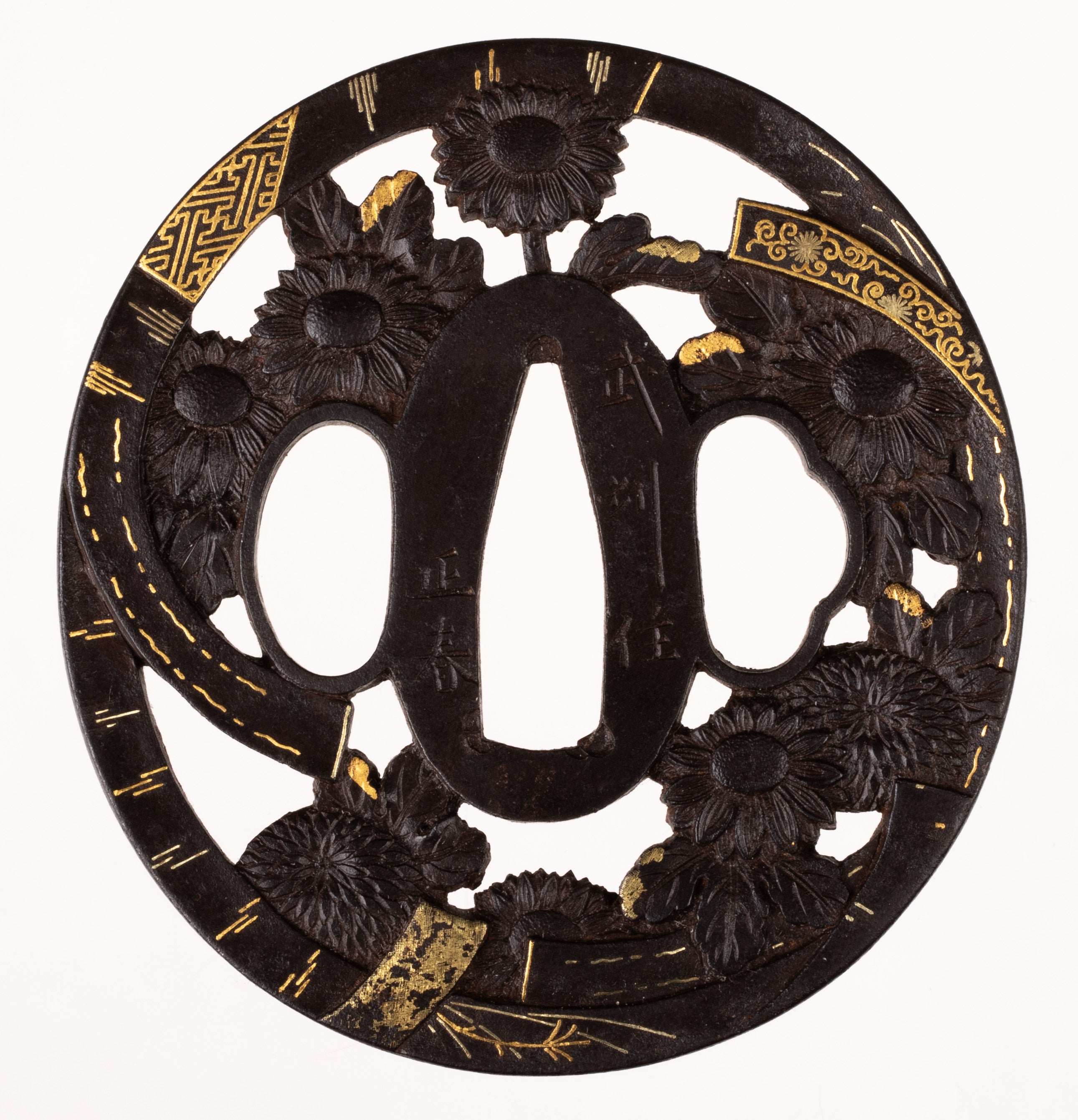 Iron tsuba signed "Bushu Masaharu". Decorated with chrysanthemum and ornamental band