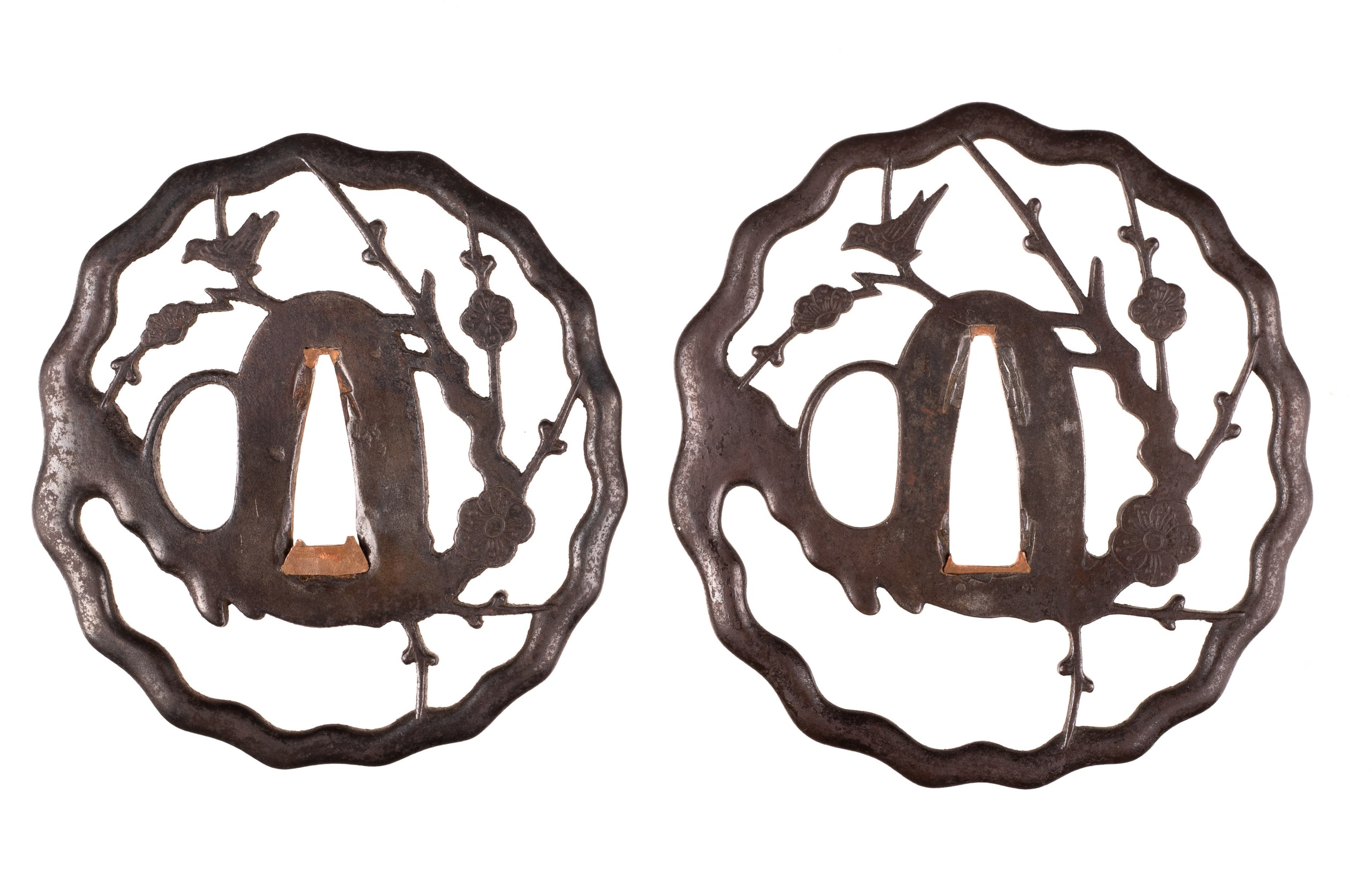 Iron sukashi daisho tsuba set decorated with a nightingale on a plum tree
